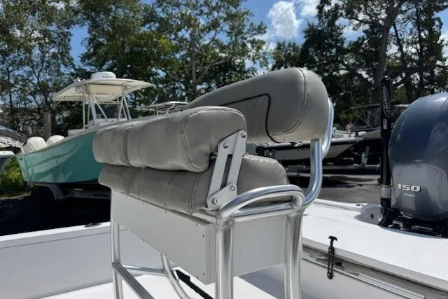 Slide: The Image of 2023 Sportsman Tournament 214 SBX Bay Boat with cushioned seating and powerful engine. - 8