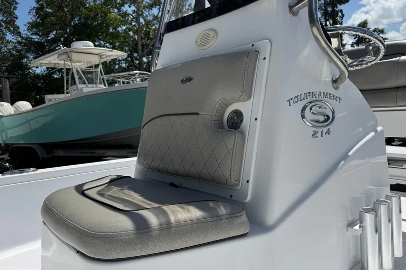 Slide: The Image of 2023 Sportsman Tournament 214 SBX Bay Boat interior with cushioned seating and steering wheel. - 9