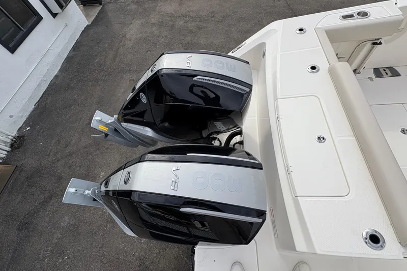 Slide: The Image of 2026 Boston Whaler 330 Outrage with dual outboard engines, top view. - 3
