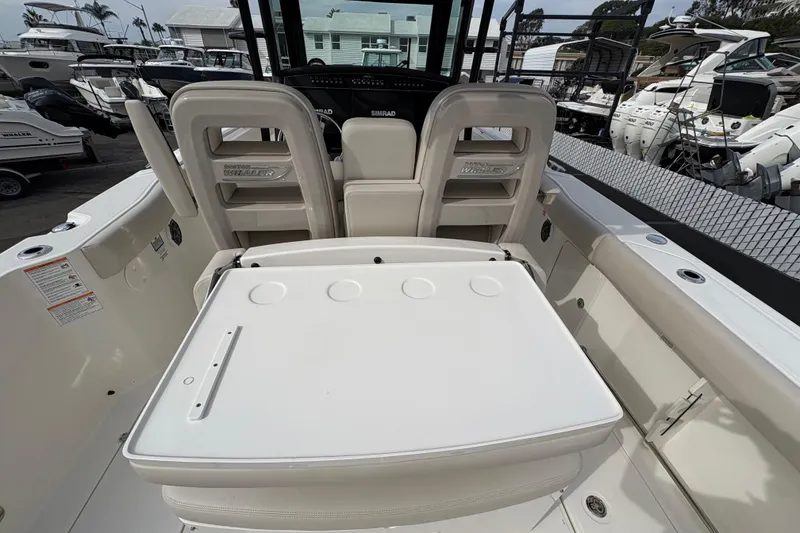 Slide: The Image of 2026 Boston Whaler 330 Outrage boat interior with seating and console view. - 6