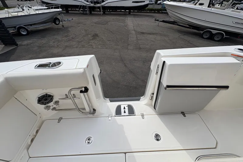 Slide: The Image of 2026 Boston Whaler 330 Outrage boat deck with storage and seating area. - 7