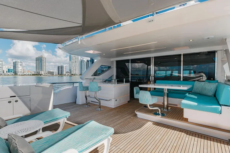 Slide: The Image of Luxurious Horizon 2021 yacht deck with seating, city skyline view, and modern amenities. - 22