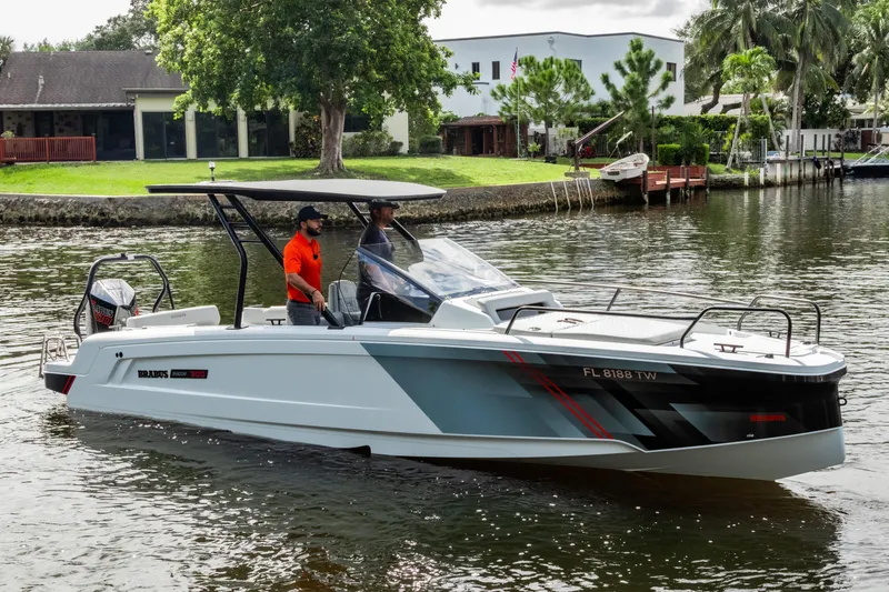 The Image of 2023 BRABUS Shadow 300 XT boat cruising on a scenic waterway. - 0