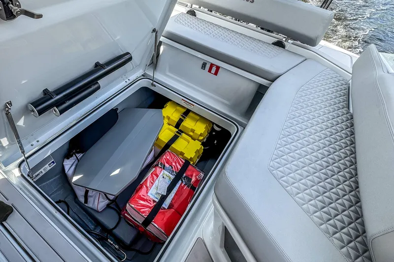 Slide: The Image of 2023 BRABUS Shadow 300 XT boat storage compartment with safety equipment and gear. - 10