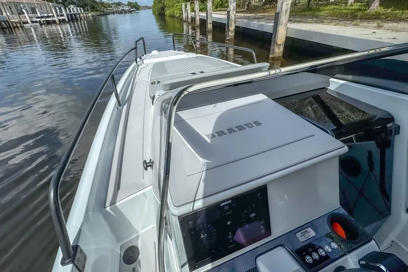 Slide: The Image of 2023 BRABUS Shadow 300 XT boat on a serene waterway. - 14