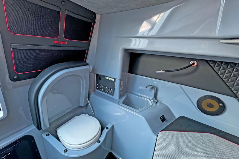Slide: The Image of Interior of 2023 BRABUS Shadow 300 XT boat, featuring a compact bathroom with sink and toilet. - 17