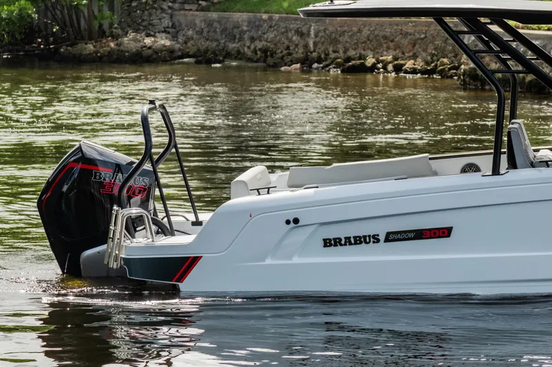 Slide: The Image of 2023 BRABUS Shadow 300 XT boat on water, showcasing sleek design and powerful engine. - 2