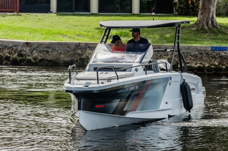 Slide: The Image of 2023 BRABUS Shadow 300 XT boat cruising on a calm waterway. - 4