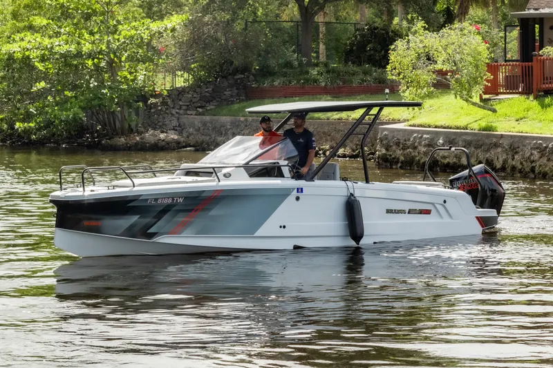 Slide: The Image of 2023 BRABUS Shadow 300 XT boat cruising on a scenic waterway. - 5