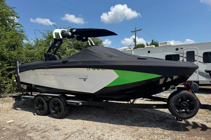 Slide: The Image of 2017 Nautique Super Air Nautique G23 boat on trailer, covered, outdoors. - 0
