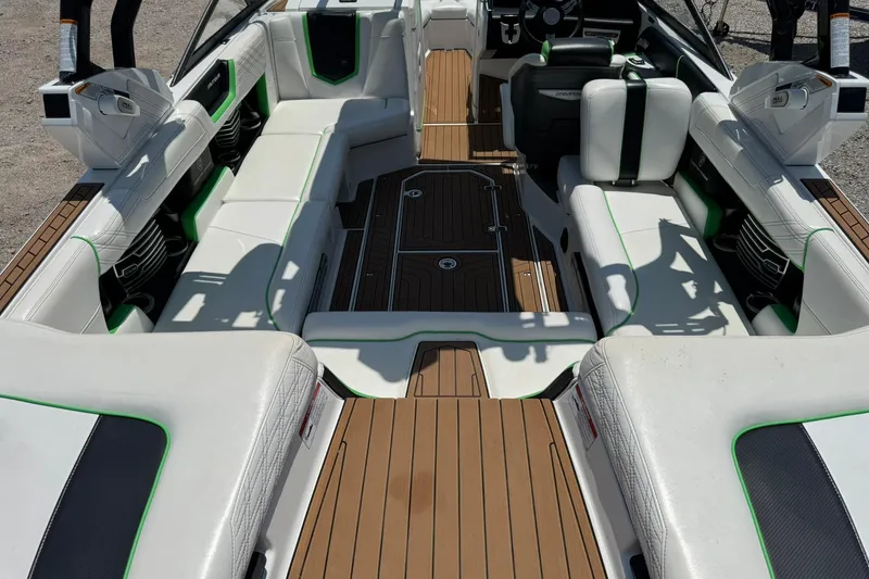 Slide: The Image of 2017 Nautique Super Air Nautique G23 interior with white seating and green accents. - 10