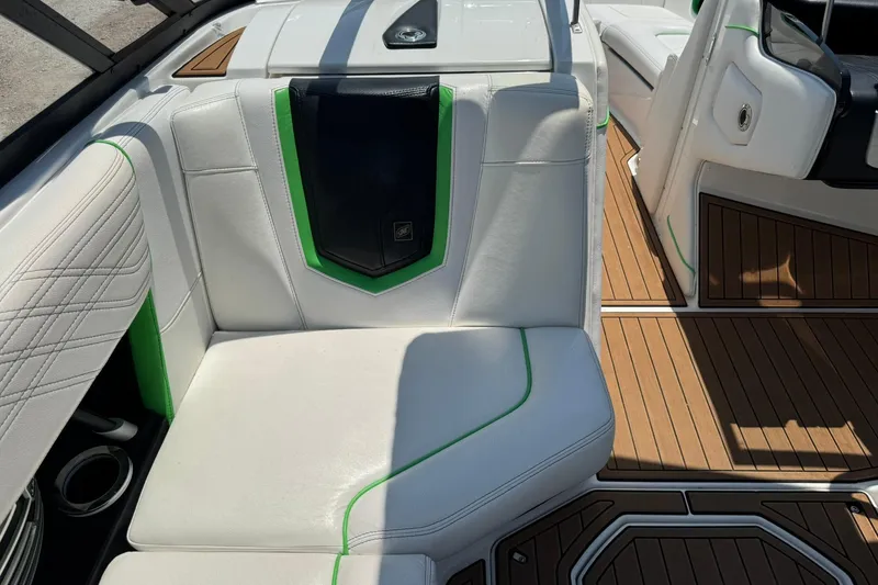Slide: The Image of 2017 Nautique Super Air Nautique G23 interior with white and green seating, teak flooring. - 11