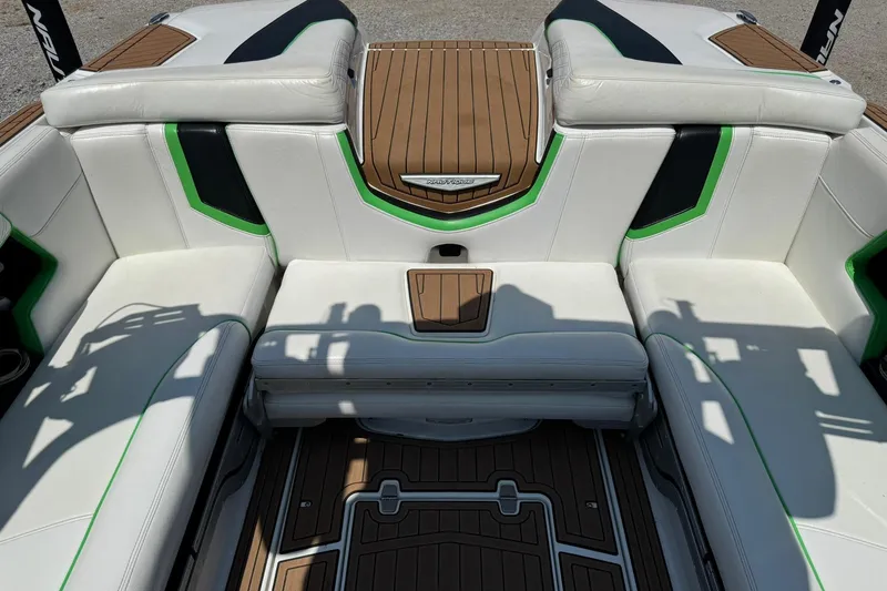 Slide: The Image of 2017 Nautique Super Air Nautique G23 interior with white and green seating, teak flooring. - 12