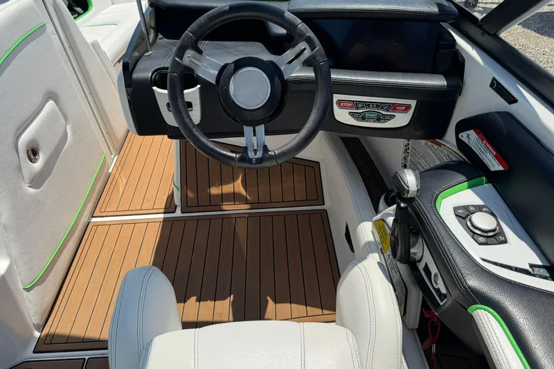 Slide: The Image of 2017 Nautique Super Air Nautique G23 boat cockpit with steering wheel and control panel. - 14
