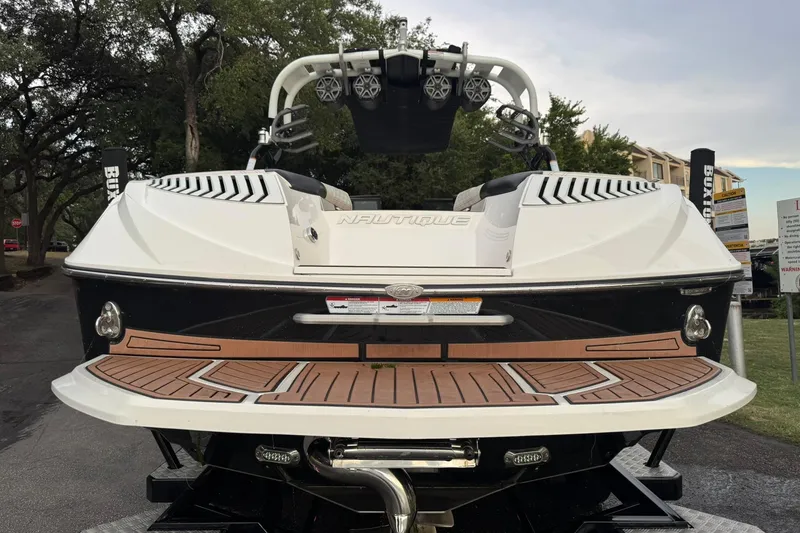 Slide: The Image of 2017 Nautique Super Air Nautique G23 boat rear view with teak deck and speakers. - 15