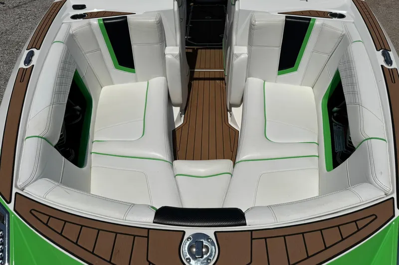 Slide: The Image of 2017 Nautique Super Air Nautique G23 boat interior with white and green seating. - 6