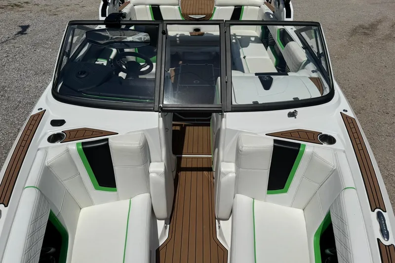 Slide: The Image of 2017 Nautique Super Air Nautique G23 interior with white seats and green accents. - 7