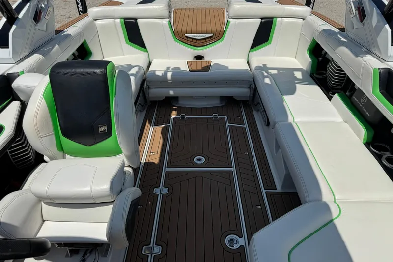 Slide: The Image of 2017 Nautique Super Air Nautique G23 interior with white and green seating, teak flooring. - 9