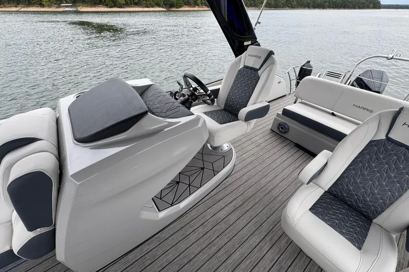 Slide: The Image of 2023 Harris Grand Mariner 250 interior with luxurious seating on a serene lake. - 13