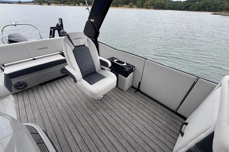 Slide: The Image of 2023 Harris Grand Mariner 250 boat interior with luxurious seating and lake view. - 14