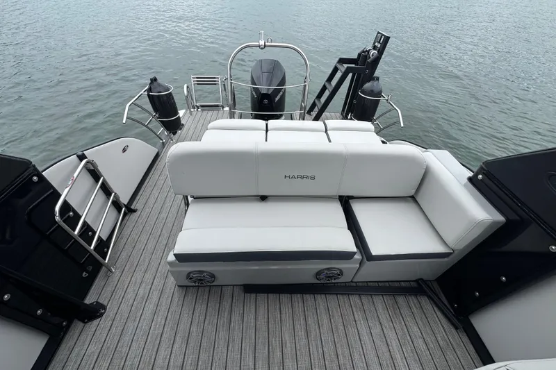Slide: The Image of 2023 Harris Grand Mariner 250 boat with luxurious seating on a calm water backdrop. - 16