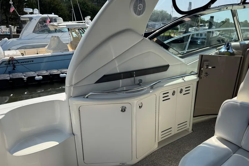 Slide: The Image of Interior view of a 2003 Sea Ray 420 Sundancer yacht, featuring sleek cabinetry and seating. - 12