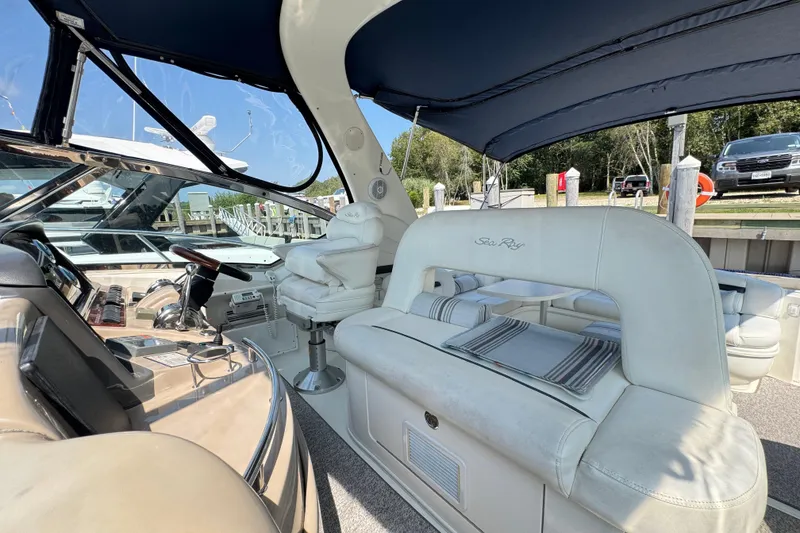 Slide: The Image of 2003 Sea Ray 420 Sundancer yacht interior with plush seating and helm station. - 13