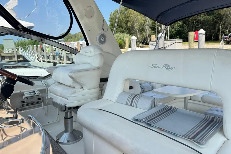 Slide: The Image of Interior of 2003 Sea Ray 420 Sundancer yacht with white seating and helm. - 14