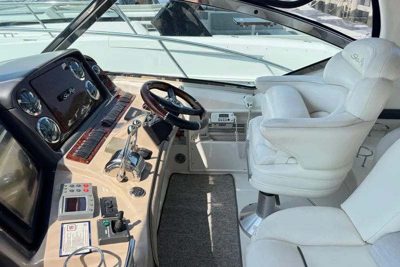 Slide: The Image of Interior cockpit of 2003 Sea Ray 420 Sundancer with steering wheel and control panel. - 15
