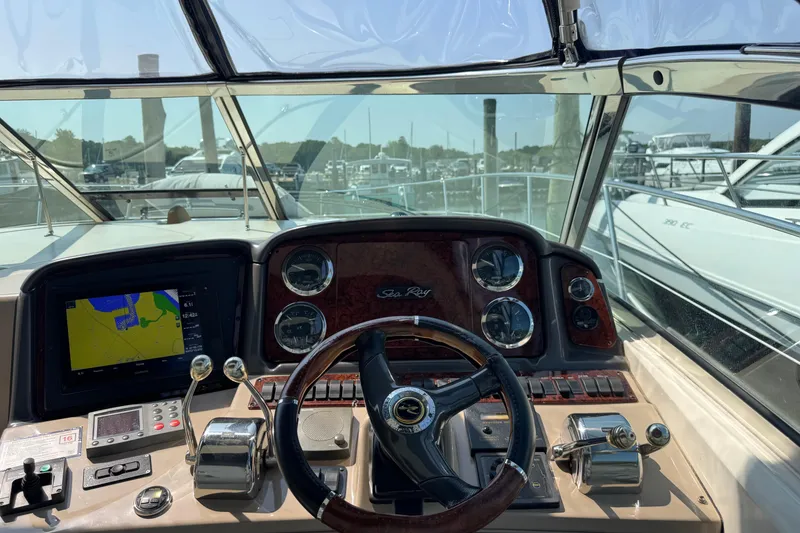 Slide: The Image of Cockpit view of 2003 Sea Ray 420 Sundancer with navigation instruments and steering wheel. - 16