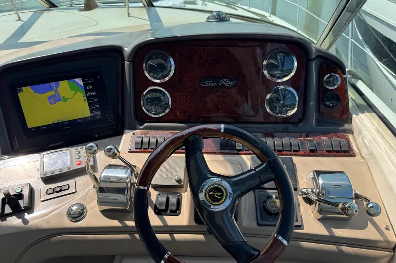 Slide: The Image of Cockpit of 2003 Sea Ray 420 Sundancer with navigation display and control panel. - 17