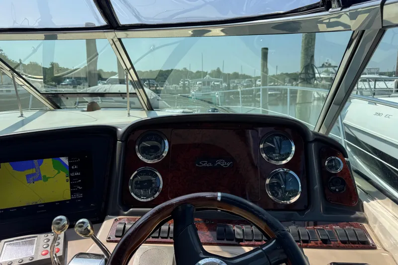 Slide: The Image of Cockpit view of 2003 Sea Ray 420 Sundancer with navigation instruments and steering wheel. - 18