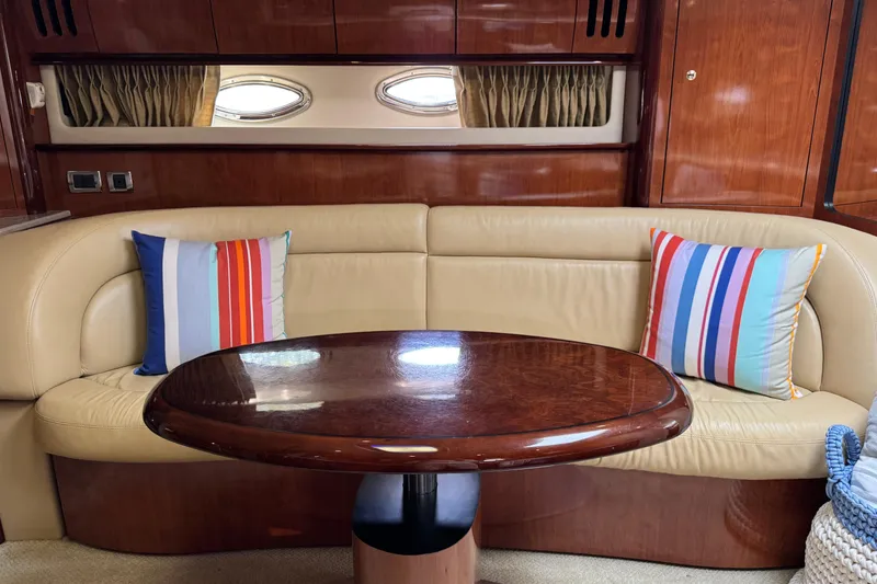 Slide: The Image of Luxurious 2003 Sea Ray 420 Sundancer interior with leather seating and colorful striped pillows. - 23