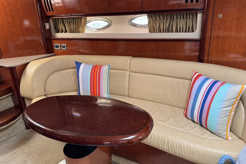 Slide: The Image of Luxurious 2003 Sea Ray 420 Sundancer interior with leather seating and colorful striped pillows. - 24