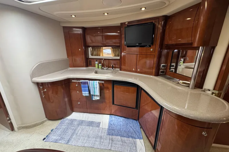 Slide: The Image of Luxurious 2003 Sea Ray 420 Sundancer yacht interior with elegant wood cabinetry and modern amenities. - 26