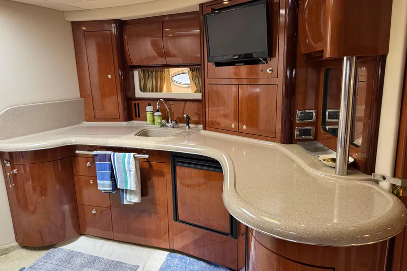 Slide: The Image of Luxurious 2003 Sea Ray 420 Sundancer yacht interior with elegant wood cabinetry and modern amenities. - 27