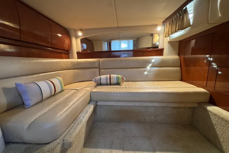 Slide: The Image of Luxurious interior of 2003 Sea Ray 420 Sundancer with plush seating and elegant wood finishes. - 28