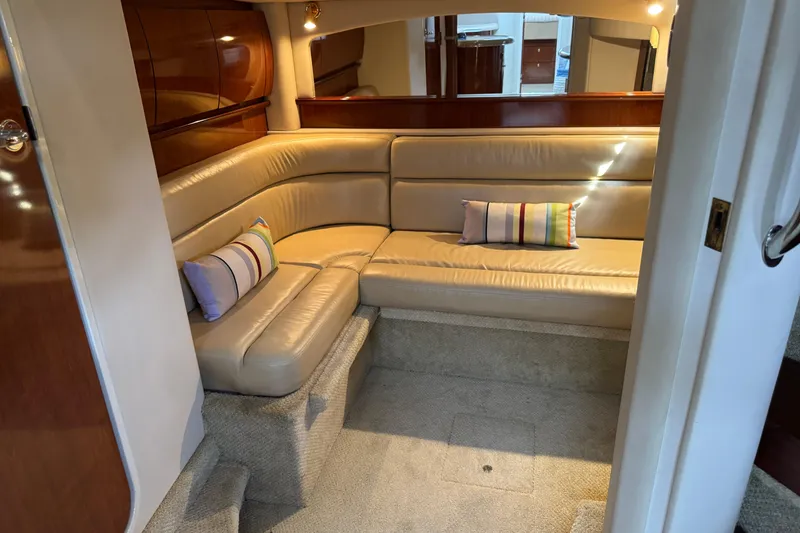 Slide: The Image of Luxurious interior of 2003 Sea Ray 420 Sundancer with beige leather seating and striped pillows. - 29