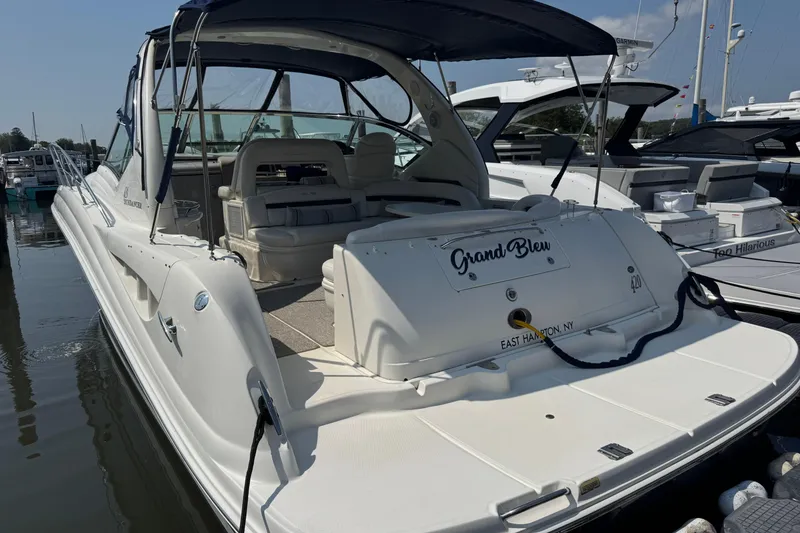 Slide: The Image of 2003 Sea Ray 420 Sundancer yacht docked, featuring spacious seating and elegant design. - 3