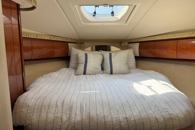 Slide: The Image of Luxurious cabin interior of 2003 Sea Ray 420 Sundancer yacht with skylight and striped bedding. - 30