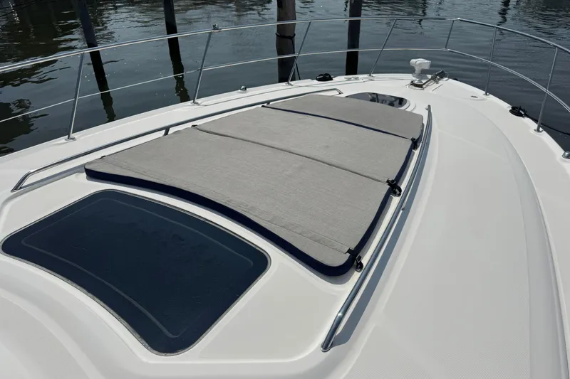 Slide: The Image of 2003 Sea Ray 420 Sundancer boat deck with sunpad and railing. - 34