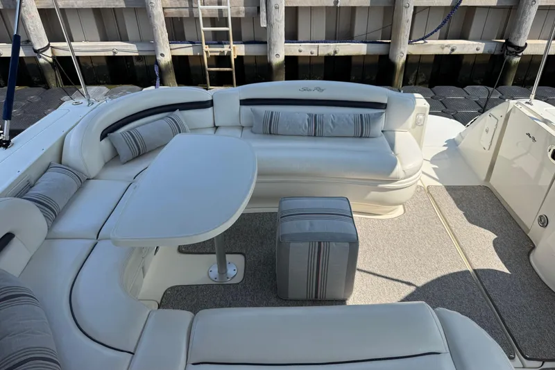 Slide: The Image of 2003 Sea Ray 420 Sundancer yacht interior with plush seating and table. - 8