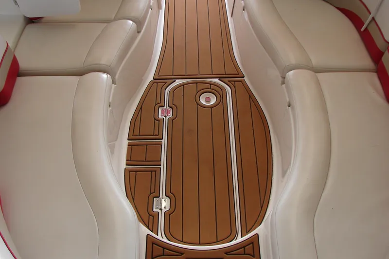Slide: The Image of 1999 CHAPPARRAL 233 Sunesta boat interior with cushioned seating and wooden flooring. - 13