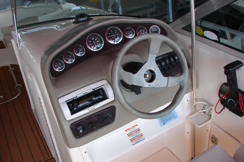 Slide: The Image of 1999 CHAPPARRAL 233 Sunesta boat dashboard with steering wheel and control panel. - 15