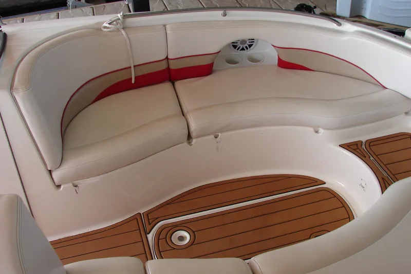 Slide: The Image of 1999 CHAPPARRAL 233 Sunesta boat interior with cushioned seating and wood-style flooring. - 17
