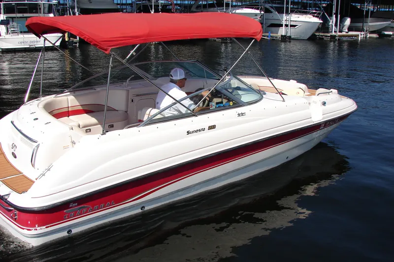 Slide: The Image of 1999 Chaparral Sunesta 233 boat with red canopy on calm water. - 2