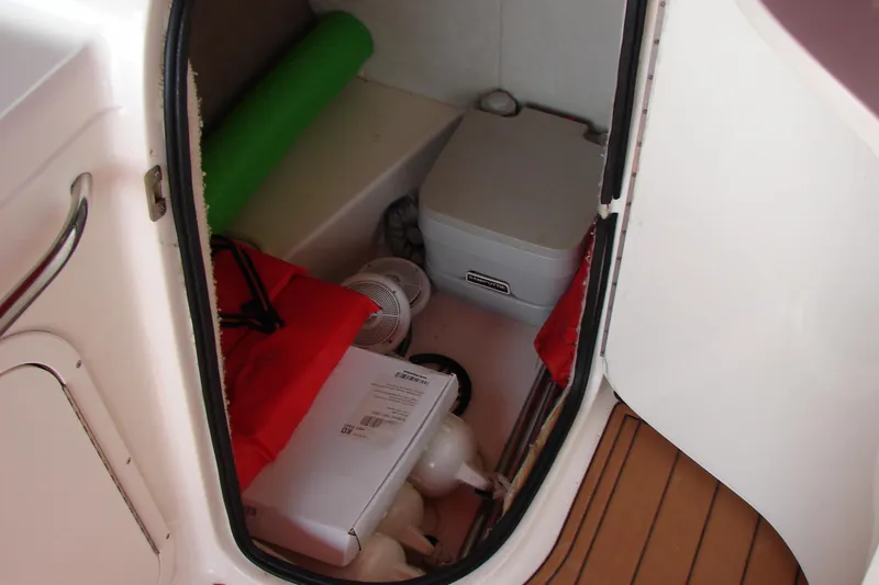 Slide: The Image of Storage compartment in 1999 CHAPPARRAL 233 Sunesta boat with various items. - 20