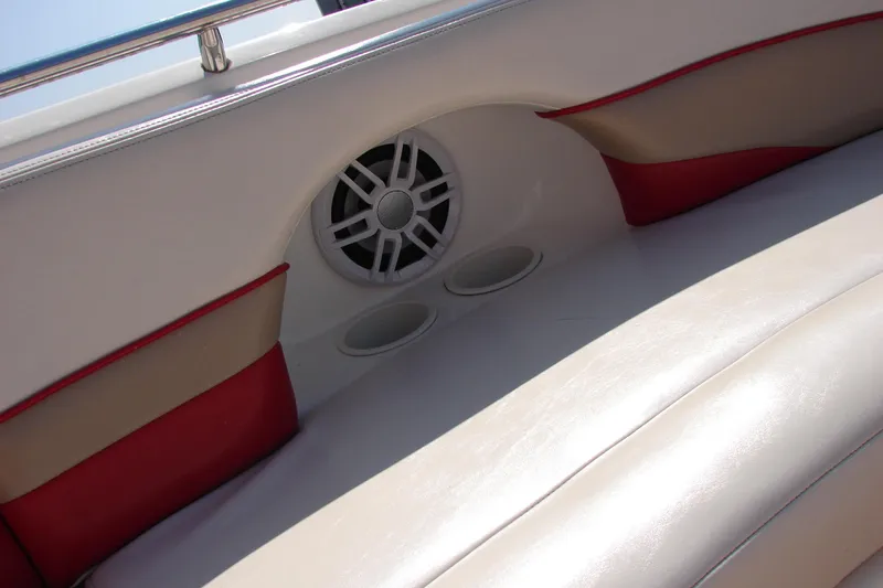 Slide: The Image of 1999 Chaparral Sunesta 233 boat interior with speaker and cup holders. - 26