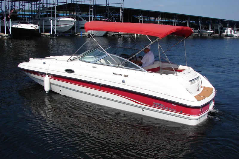 Slide: The Image of 1999 Chaparral Sunesta 233 boat with red canopy on calm water. - 7