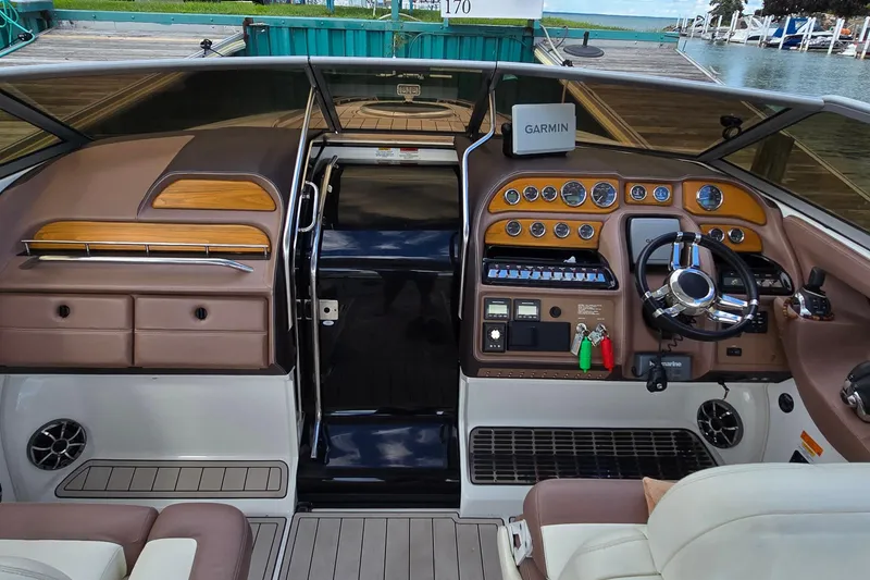 Slide: The Image of Interior of a 2011 Cobalt 323 boat with Garmin navigation system and luxurious dashboard. - 14